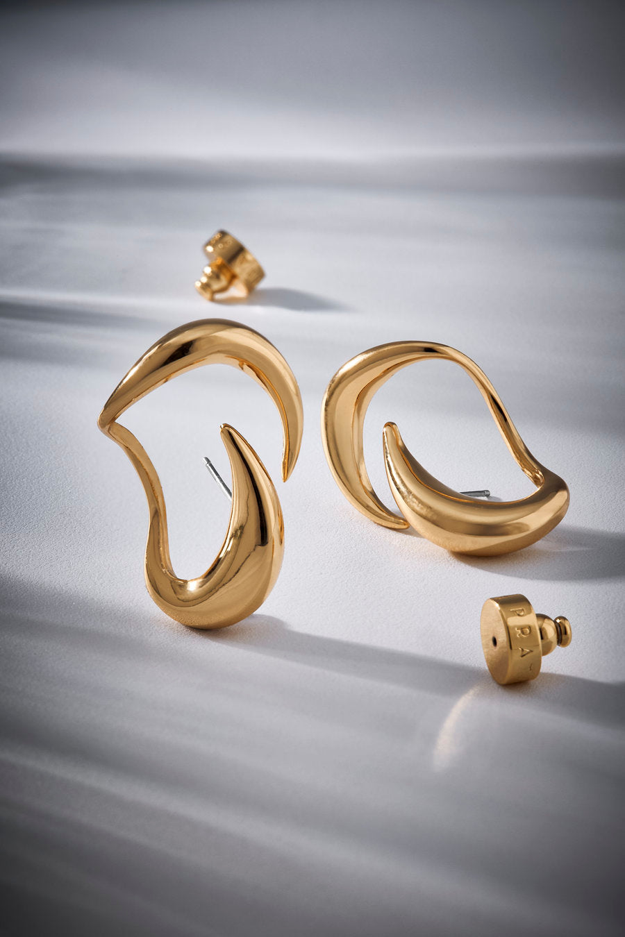 Brinco Passaggio em metal nobre com banho ouro 18k – acabamento polido e formas esculturais