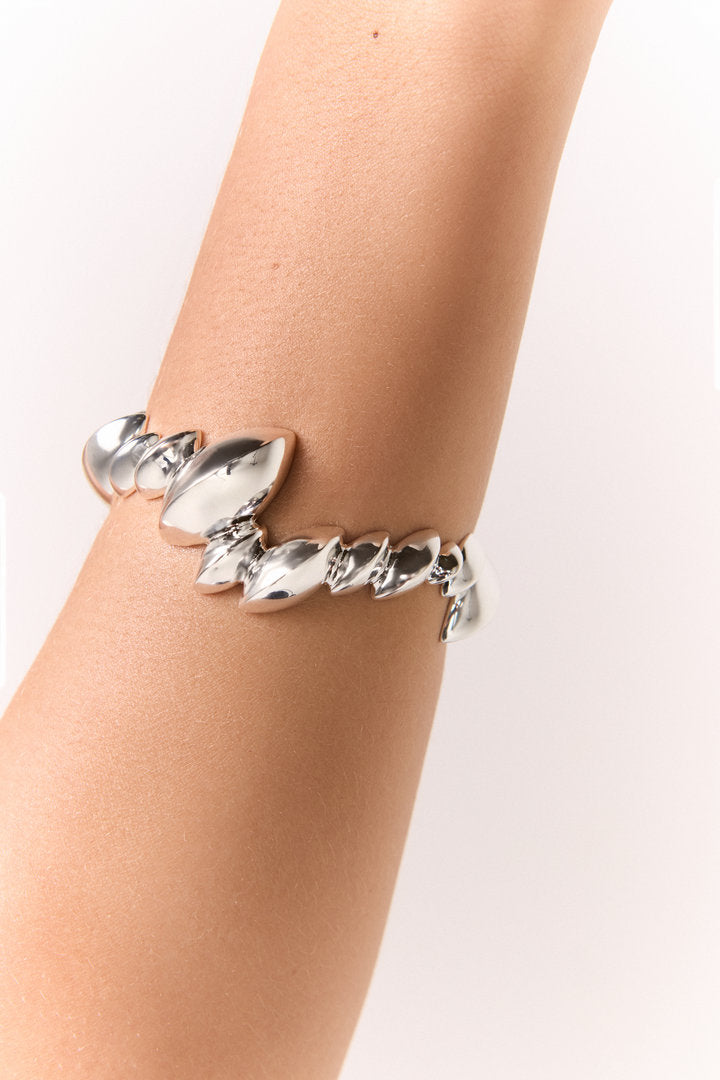 Bracelete Trama prata com inspiração botânica, folhas sobrepostas e brilho intenso para looks sofisticados.