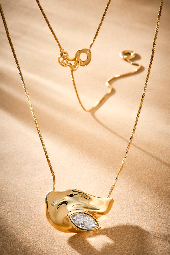Colar Elsa dourado com cristal lapidado e pingente escultural para composições elegantes